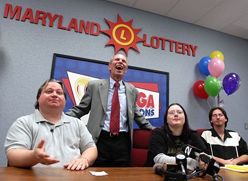 Ellwood "Bunky" Bartlett from Dundalk is shown at the Maryland Lottery with his children, Ashley, 18, and Ryan, 21, where he got his ticket verified. Also pictured is Lottery Director Buddy Roogow.