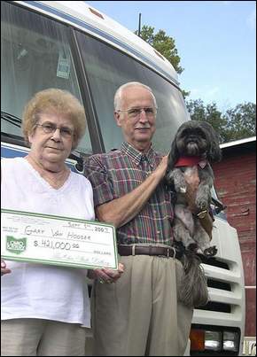 Gary and Phyllis VanHooser with their dog Maxie in front of the RV they plan to take around the country. Maxie travels everywhere with the VanHoosers and rides up front with Gary. "He's my co-pilot," Gary said.