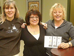 Powco employees Karen Hodgins, Dora Reame and Christina Tyhaar-Barnes hold a photocopy of their $24.5 million 6/49 ticket yesterday.