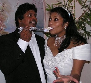 Arnim Ramdass and Donna Campbell eat wedding cake while they celebrate their marriage in 2005.