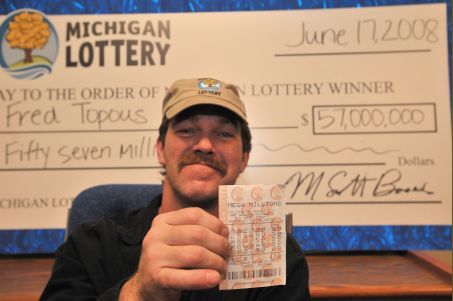 Fred Topous shows the Mega Millions lottery ticket that brought him a $34 million lump-sum payout. 