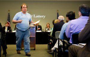 Tony Scheessele, owner of the South Britain Country Store, walks back to his seat after addressing the board that oversees the Connecticut Lottery.